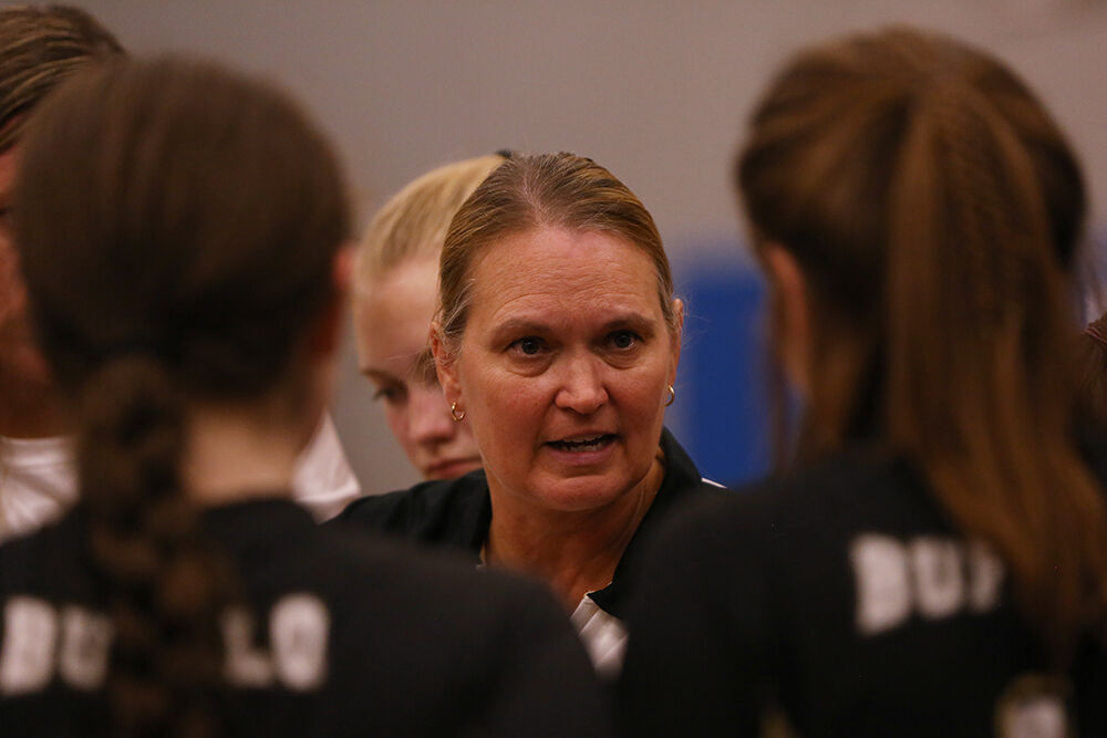 Michelle Dahlberg talks with her team